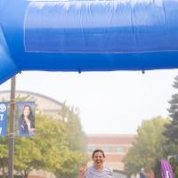 Participant crossing finish line while holding "anchor up"